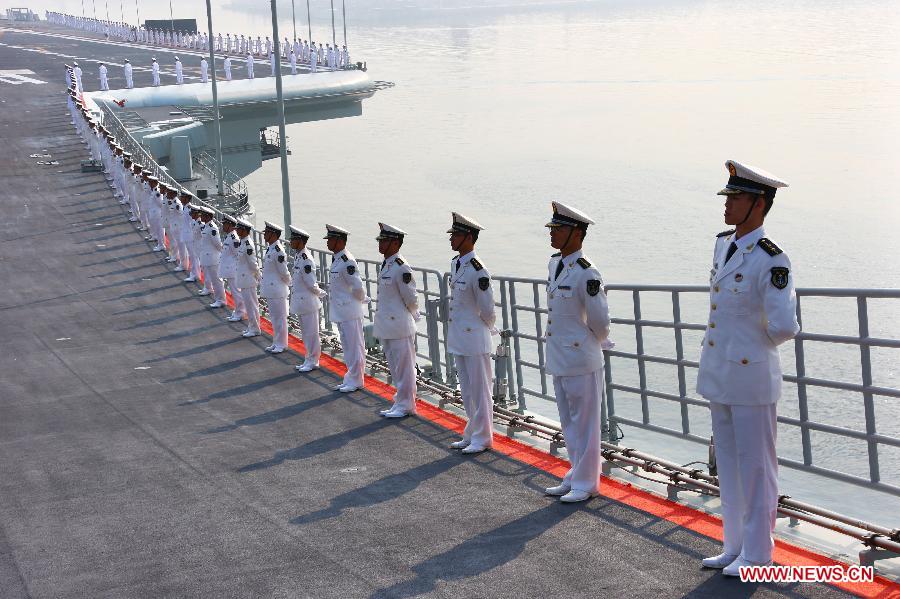 Military officers stand onboard China's aircraft carrier "Liaoning" in Dalian, northeast China's Liaoning Province, Sept. 25, 2012.  (Xinhua File Photo/Zha Chunming)