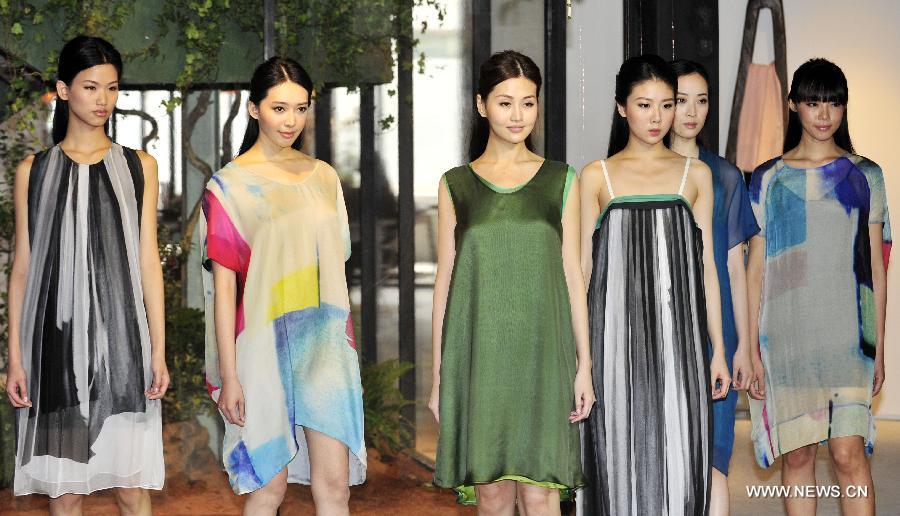 Models present fashion creations designed by Jamei Chen in Taipei, southeast China's Taiwan, Feb. 26, 2013. (Xinhua/Wu Ching-teng)