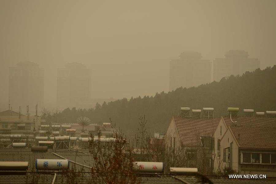 Residential buildings are seen engulfed by a hazy day in Jinan, capital of east China's Shandong Province, Feb. 28, 2013. Pollution worsened in China's north and east provinces as a sand storm hit the region on Thursday. (Xinhua/Guo Xulei)