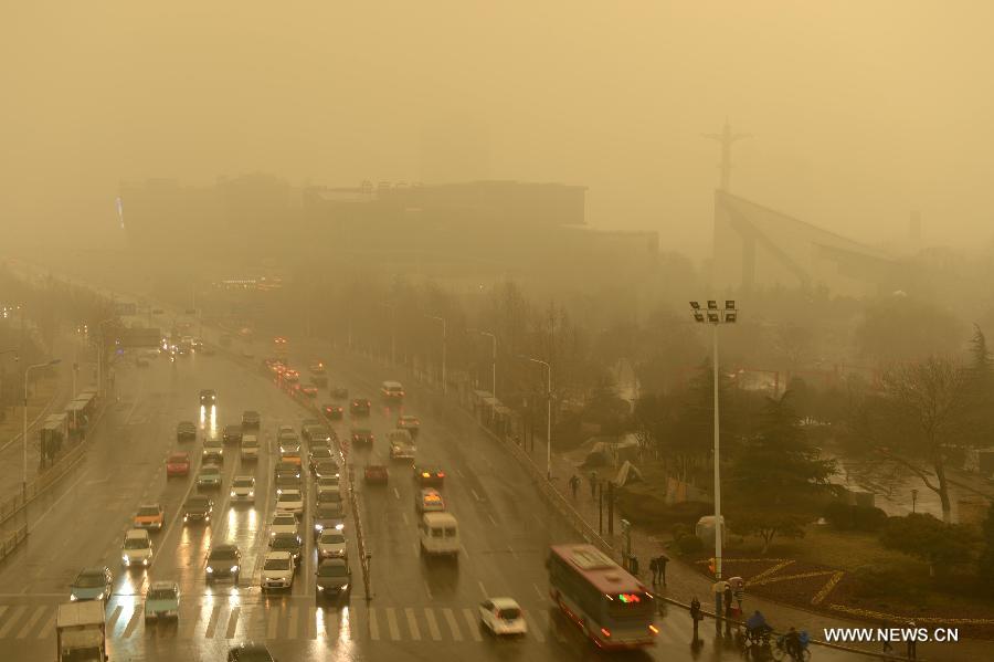 Vehicles move as they are engulfed by a hazy day in Jinan, capital of east China's Shandong Province, Feb. 28, 2013. Pollution worsened in China's north and east provinces as a sand storm hit the region on Thursday. (Xinhua/Guo Xulei) 
