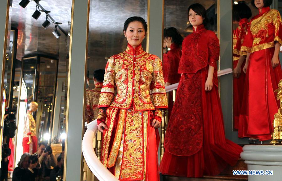 Models present creations by designer Guo Pei at the "Chinese Bride" flagship store in No. 22 Waitan in Shanghai, east China, March 2, 2013. A wedding dress show was held by Guo Pei, the owner of the flagship store "Chinese Bride" and also a prominent designer who has created ceremonial dresses for both the CCTV Spring Festival Gala and the 2008 Beijing Olympics. (Xinhua/Zhang Ming)