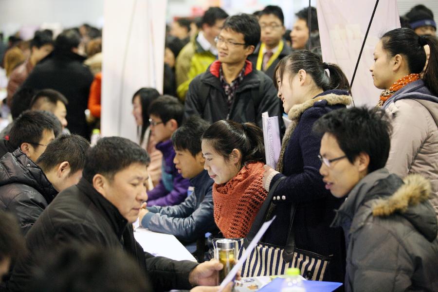 Job seekers consult employment information at a job fair in Nanjing, capital of east China's Jiangsu Province, March 2, 2013. More than 20,000 job opportunities were offered at the job fair. (Xinhua/Wang Xin) 