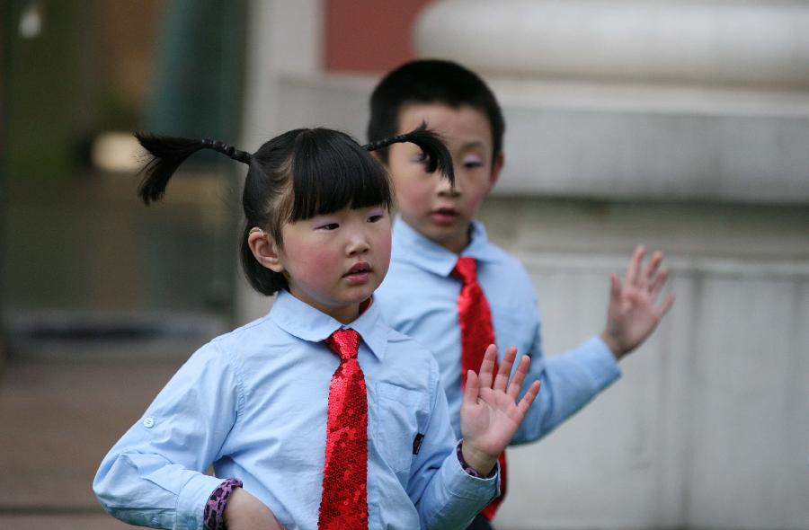 Pupils with hearing impairment perform during a public welfare activity on the Ear-care Day in Nanjing, capital of east China's Jiangsu Province, March 3, 2013. (Xinhua/Yan Minhang)