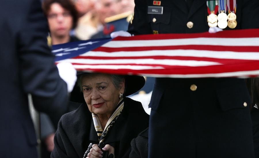 Brenda Schwarzkopf, widow of the late U.S. Four Star General H. Norman Schwarzkopf, looks on as an American flag is folded over his grave during his burial service at the United States Military Academy at West Point, New York, February 28, 2013. Schwarzkopf, who graduated from West Point in 1956, commanded the U.S.-led international coalition that drove Saddam Hussein's forces out of Kuwait in 1991.  (Xinhua/Reuters Photo)