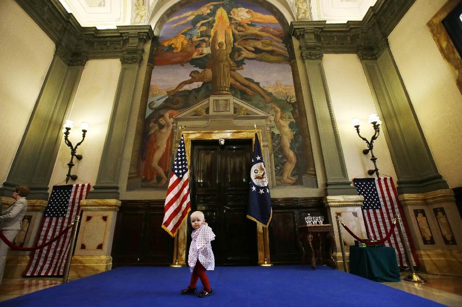 Victoria Tribe, 1, whose father works at the U.S. Embassy in Rome, walks across a set stage as people wait for a visit from U.S. Secretary of State John Kerry, at the embassy in Rome February 28, 2013.  (Xinhua/Reuters Photo)