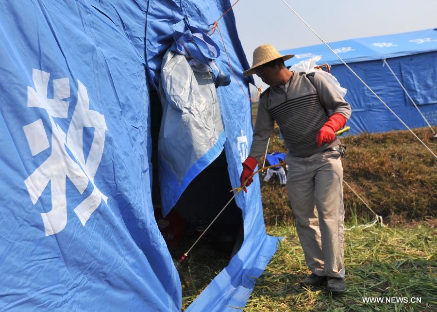 A worker sprays disinfectant in a relief tent at Qiandian Village of Liantie Township in Eryuan County of Dali Bai Autonomous Prefecture, southwest China's Yunnan Province, March 4, 2013. A 5.5-magnitude earthquake hit Eryuan County on March 3. Thirty people have been confirmed injured, while some 21,000 people have been evacuated. (Xinhua/Lin Yiguang) 