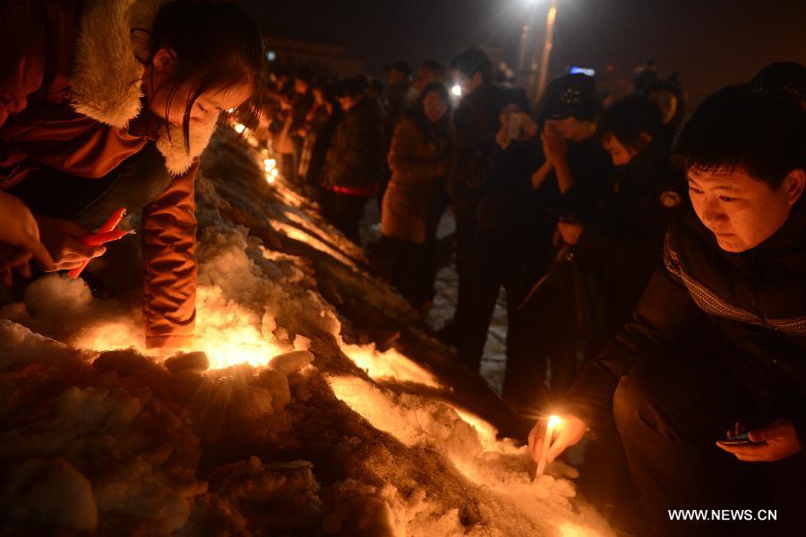 Local residents gather to mourn for the baby who was strangled to death by a car stealer in Changchun, capital of northeast China's Jilin Province, March 5, 2013. Zhou Xijun, 48, native of the Gongzhuling City of Jilin, stole a gray Toyota RAV4 SUV on March 4 in Changchun. Zhou drove the jeep on the highway and found a baby on the backseat. He parked the jeep on the roadside and then strangled the baby. (Xinhua/Lin Hong) 