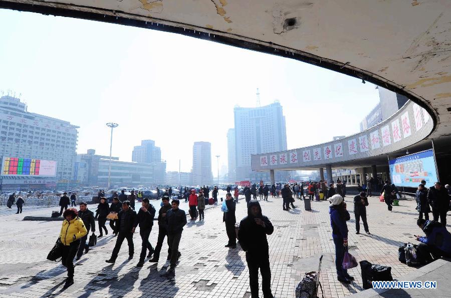 Passengers walk on the square outside the railway station in Harbin, capital of northeast China's Heilongjiang Province, March 6, 2013. The 40-day Spring Festival travel rush, started on Jan. 26 this year, came to the last day on Wednesday. The Spring Festival, which falls on Feb. 10 this year, is traditionally the most important holiday of the Chinese people. It is a custom for families to reunite in the holiday, a factor that has led to massive seasonal travel rushes in recent years as more Chinese leave their hometowns to seek work elsewhere. (Xinhua/Wang Song) 