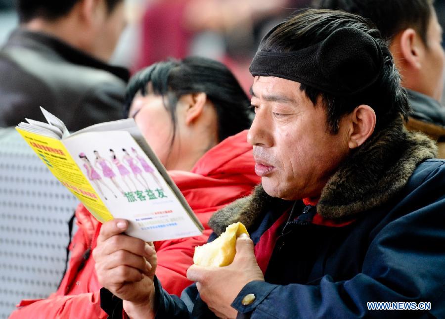 A passenger reads in a waiting hall at the railway station in Harbin, capital of northeast China's Heilongjiang Province, March 6, 2013. The 40-day Spring Festival travel rush, started on Jan. 26 this year, came to the last day on Wednesday. The Spring Festival, which falls on Feb. 10 this year, is traditionally the most important holiday of the Chinese people. It is a custom for families to reunite in the holiday, a factor that has led to massive seasonal travel rushes in recent years as more Chinese leave their hometowns to seek work elsewhere. (Xinhua/Wang Song)