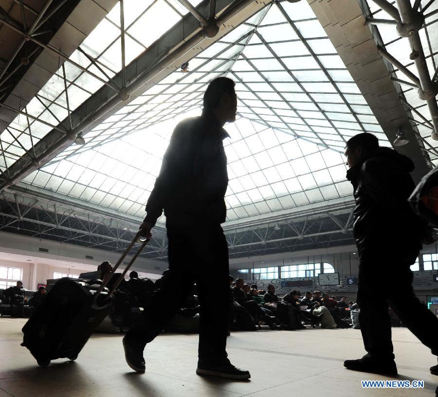 Passengers walks in a waiting hall at the railway station in Harbin, capital of northeast China's Heilongjiang Province, March 6, 2013. The 40-day Spring Festival travel rush, started on Jan. 26 this year, came to the last day on Wednesday. The Spring Festival, which falls on Feb. 10 this year, is traditionally the most important holiday of the Chinese people. It is a custom for families to reunite in the holiday, a factor that has led to massive seasonal travel rushes in recent years as more Chinese leave their hometowns to seek work elsewhere. (Xinhua/Wang Song)