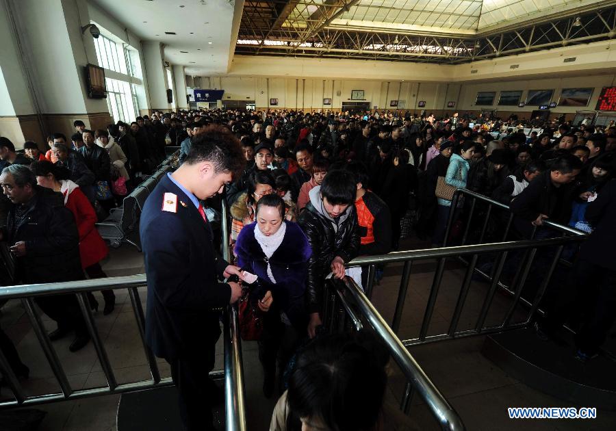 Passengers have their tickets checked at the railway station in Harbin, capital of northeast China's Heilongjiang Province, March 6, 2013. The 40-day Spring Festival travel rush, started on Jan. 26 this year, came to the last day on Wednesday. The Spring Festival, which falls on Feb. 10 this year, is traditionally the most important holiday of the Chinese people. It is a custom for families to reunite in the holiday, a factor that has led to massive seasonal travel rushes in recent years as more Chinese leave their hometowns to seek work elsewhere. (Xinhua/Wang Song)