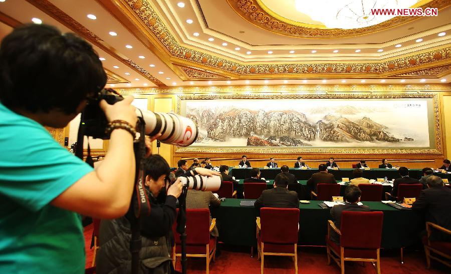 A photographer works at a discussion of deputies to the 12th National People's Congress (NPC) from Beijing, in Beijing, capital of China, March 6, 2013. The discussion which was held by the Beijing delegation to the first session of the 12th NPC was open to media on Wednesday. (Xinhua/Wang Shen)