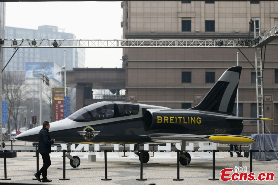 A full-size fighter jet model is put on display to mark the opening of a watch store at the Wangfujing Street in Beijing, March 6, 2013. (CNS/Fu Tian)