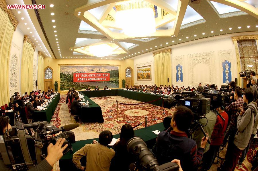 Deputies to the 12th National People's Congress (NPC) from northwest China's Xinjiang Uygur Autonomous Region take part in a discussion in Beijing, capital of China, March 7, 2013. The discussion which was held by the Xinjiang delegation to the first session of the 12th NPC was open to media on Thursday. (Xinhua/Chen Jianli)
