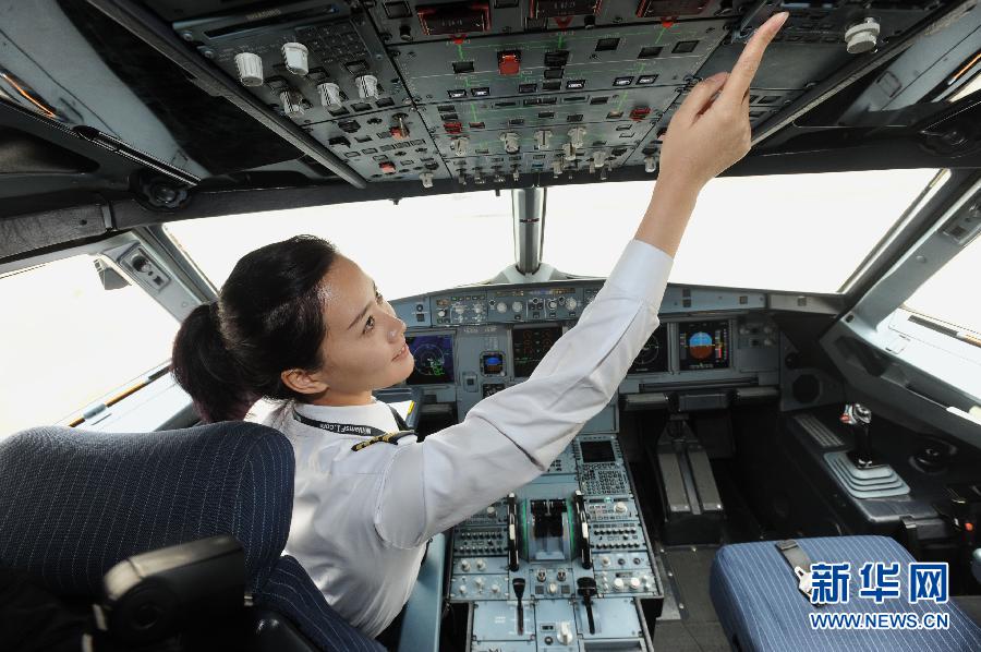 Li does routine inspection before takeoff on March 7, 2013. Li Ying, born in 1986, was formally transferred to the North Branch of Southern Airline in June 2011 as copilot in the Airbus A320 fleet. She piloted the airplane from Shenyang to Shenzhen as a captain for the first time on March 8, 2013.(Photo/Xinhua)