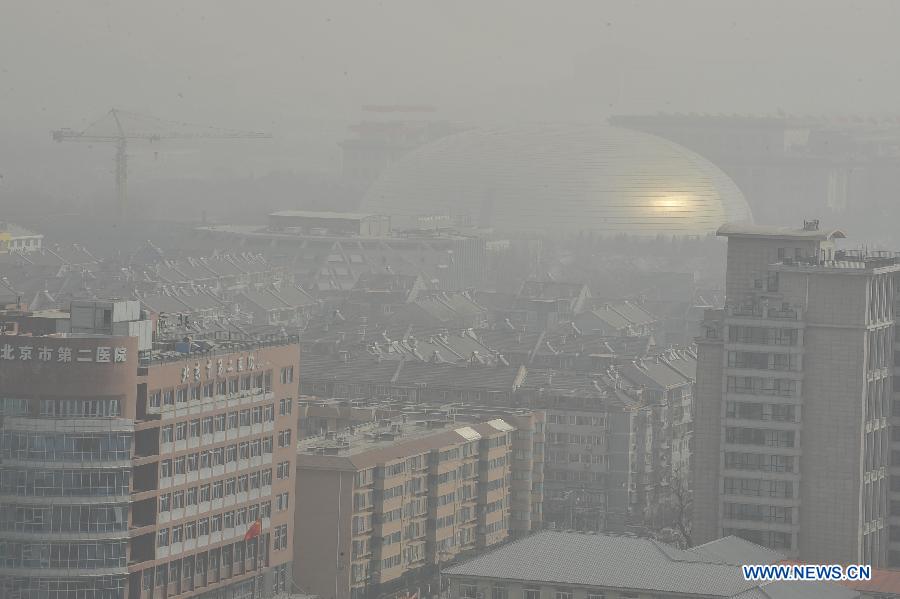 Sand and dust blanket buildings in Beijing, capital of China, March 9, 2013. A cold front brings strong wind as well as sand and dust to Beijing on March 9. (Xinhua/Lu Peng)
