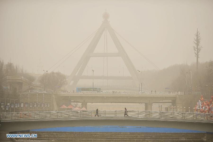 Sand and dust shroud the city of Xining, capital of northwest China's Qinghai Province, March 9, 2013. A cold front brought strong wind as well as sand and dust to the city on Saturday. (Xinhua/Wu Gang)