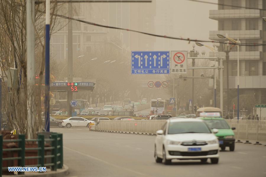 Sand and dust shroud the city of Xining, capital of northwest China's Qinghai Province, March 9, 2013. A cold front brought strong wind as well as sand and dust to the city on Saturday. (Xinhua/Wu Gang)