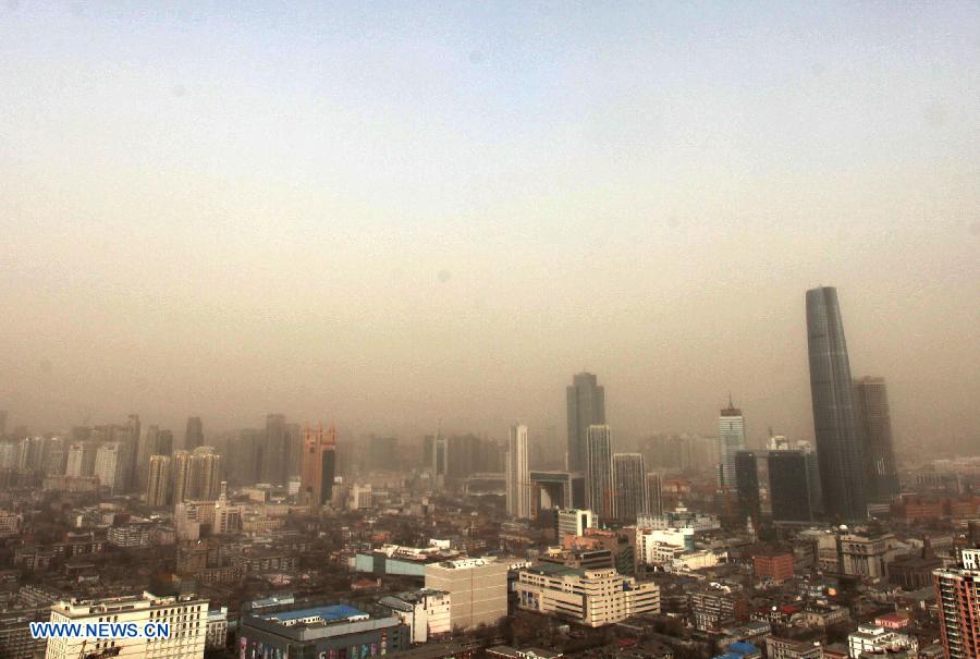 Sand and dust blanket buildings in Tianjin, north China, March 9, 2013. A cold front brought strong wind as well as sand and dust to most part of north China region on March 9. (Xinhua/He Huaqiao)