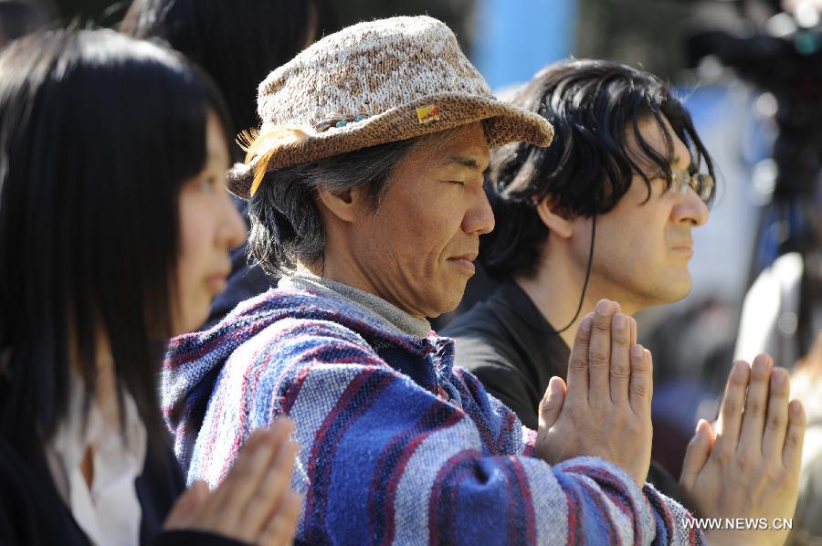 People attend a mourning ceremony in Tokyo, capital of Japan, on March 11, 2013. A mourning ceremony was held here Monday to mark the two year anniversary of the March 11 earthquke and ensuing tsunami that left more than 19,000 people dead or missing and triggered a nuclear accident the world had never seen since 1986. (Xinhua/Kenichiro Seki) 