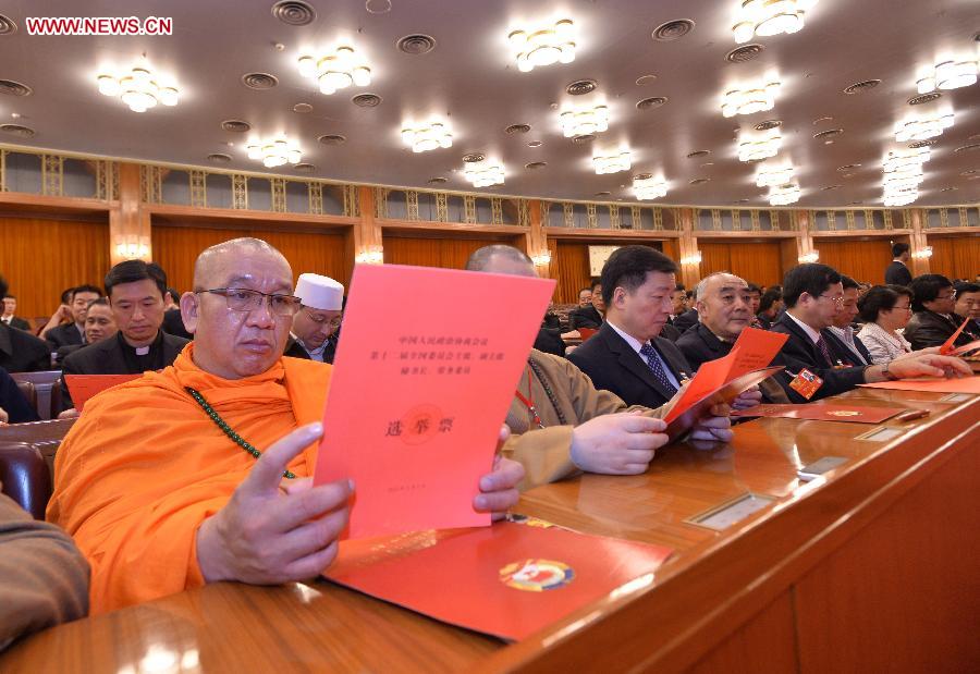 Members of the 12th National Committee of the Chinese People's Political Consultative Conference (CPPCC) check their ballots at the fourth plenary meeting of the first session of the 12th CPPCC National Committee at the Great Hall of the People in Beijing, capital of China, March 11, 2013. Chairman, vice-chairpersons, secretary-general and Standing Committee members of the 12th CPPCC National Committee will be elected here on Monday afternoon. (Xinhua/Wang Ye)