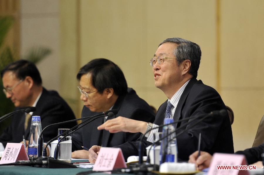 Zhou Xiaochuan (1st R), China's central bank governor, speaks at a news conference on China's currency policy and financial reform held by the first session of the 12th National People's Congress (NPC) in Beijing, capital of China, March 13, 2013. (Xinhua/Wang Peng)