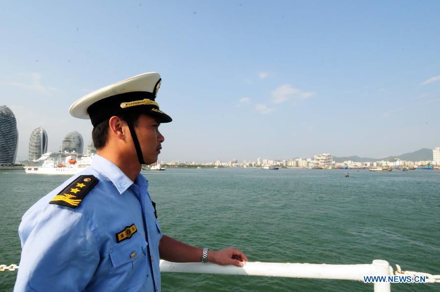 The commander of the Haijian 263 ship of China Marine Surveillance (CMS) detachement observes at the bow before the ship anchors the Sanya Harbor of south China's Hainan Province, March 14, 2013. The CMS detachment finished its patrol of the Xisha Islands in the South China Sea and was back to Sanya on Thursday afternoon. (Xinhua/Wei Hua)