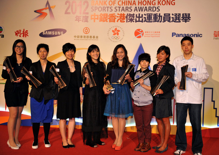 "Hong Kong Sports Stars" award winners Jiang Tianyi (Table tennis), Chan Hei Man Hayley Victoria (Windsurfing), Geng Xiaoing (Wushu), Sarah Lee Wai Sze (Cycling). Yu Chui Yee (Physically Disabled - Wheelchair Fencing), Yip Pui Yin (Badminton), Wong Ka Man (Intellectually Disabled – Table Tennis), and Ng On Yee (Billiard), take a group photo on the podium at the Hong Kong Convention and Exhibition Centre on March 14, 2013. (Xinhua/Lu Binghui)