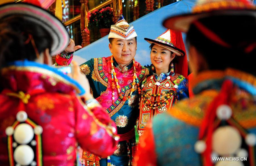Newly-wed couples pose for a photo in a traditional wedding of Yugur ethnic group in Lanzhou, northwest China's Gansu Province, March 16, 2013. Many of Yugur ethnic group, living primarily in Sunan Yugur Autonomous County in Gansu Province, still prepfer to follow their traditional wedding form in modern days. (Xinhua/Zhang Meng) 