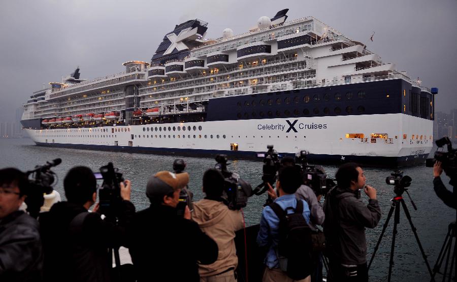 Journalists gather at the Kai Tak Cruise Terminal as the cruise ship GTS Millennium pulls into its berth in south China's Hong Kong, March 16, 2013. GTS Millennium arrived at Hong Kong's Kai Tak Cruise Terminal on Saturday and became the first cruise ship to berth at the terminal prior to its official opening in June 2013. (Xinhua/Chen Xiaowei) 