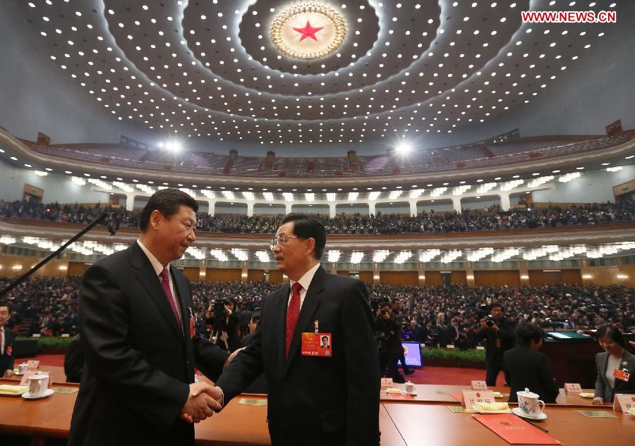 Xi Jinping (L) shakes hands with Hu Jintao at the closing meeting of the first session of the 12th National People's Congress (NPC) at the Great Hall of the People in Beijing, capital of China, March 17, 2013. (Xinhua/Lan Hongguang) 