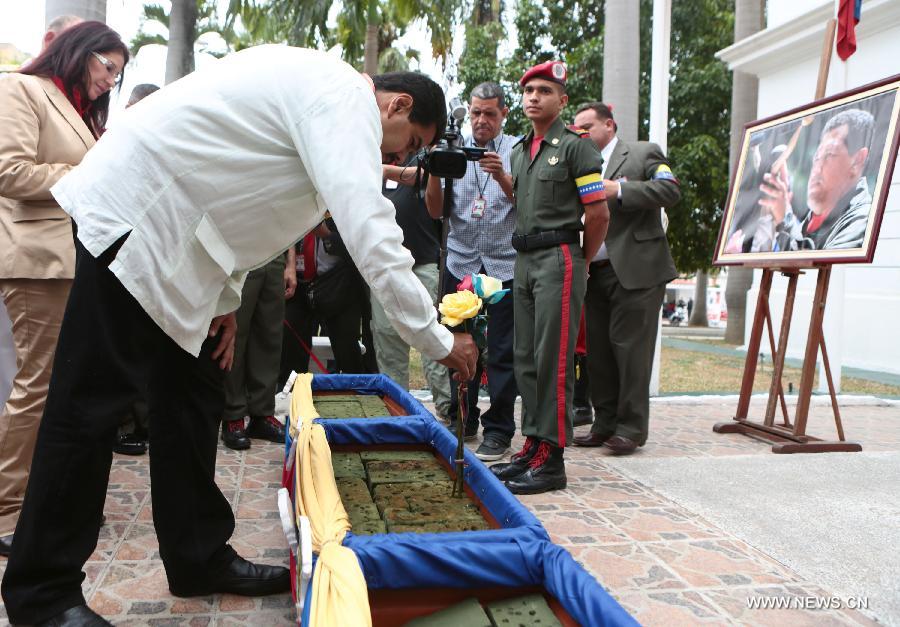 Image provided by Presidency of Venezuela shows Nicolas Maduro, commander in chief of the Bolivarian National Armed Forces, also Venezuela's Acting President, presenting flowers during a ceremony commemorating the 14 years of government of the late Venezuelan President Hugo Chavez, in Caracas, capital of Venezuela, on March 17, 2013. (Xinhua/Presidency of Venezuela) 