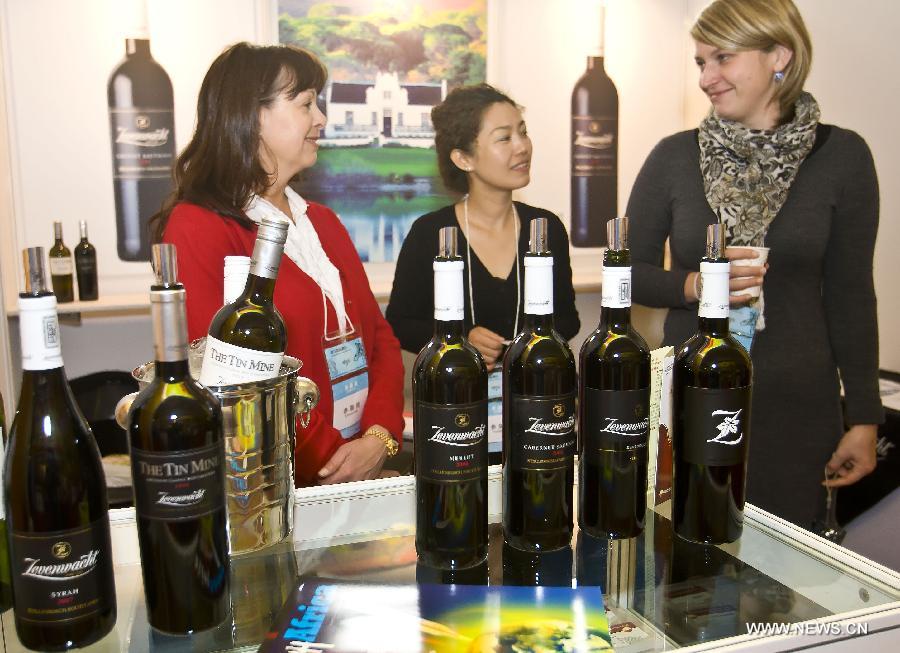 Visitors show interest in wine produced in South Africa at the Beijing Exhibition Center in Beijing, capital of China, Nov. 24, 2011. China-Africa economic and trade cooperation is mutually beneficial, strongly boosting the common development of the two sides. Chinese President Xi Jinping will visit Tanzania, South Africa and the Republic of Congo later this month and attend the fifth BRICS summit on March 26-27 in Durban, South Africa. (Xinhua/Zhao Bing) 