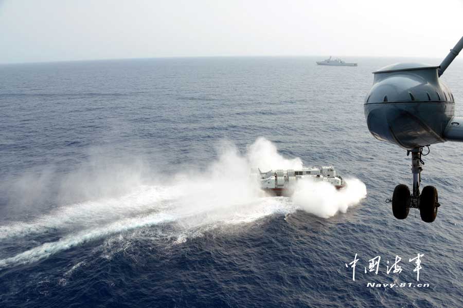The Jinggangshan landing vessel under a landing ship flotilla of the South Sea Fleet of the Navy of the Chinese People's Liberation Army (PLA) and a certain type of air-cushion craft known as "sea mustang" in a high-sea coordination training, March 20, 2013. (navy.81.cn/Qian Xiaohu, Gao Yi, Zhu Hongbin)