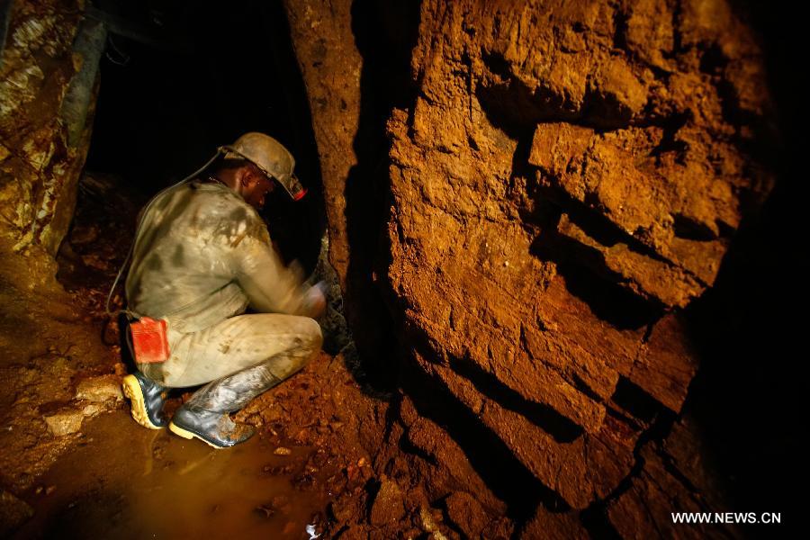 Image taken on March 26, 2013 shows a miner extracting gold in a mine at the municipality of Suarez, in Cauca, Colombia. Suarez is known for its gold deposits and mines. Around 80 percent of its population works searching for gold, despite the ongoing dispute with multinational companies and groups operating outside the law. (Xinhua/Jhon Paz) 