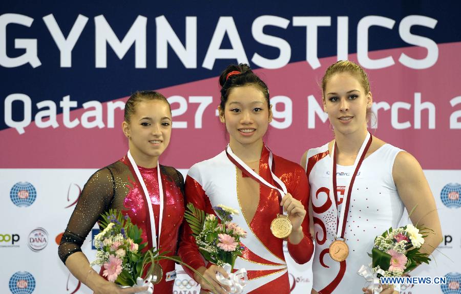 Gold medalist Phan Thi Ha Thanh (C) of Vietnam, silver medalist Larisa Andreea Iordache (L) of Romania and bronze medalist Giulia Steingruber of Switzerland pose for pictures during the awarding ceremony for women's vault at the 6th FIG Artistic Gymnastics world Challenge Cup in Doha, Qatar, March 28, 2013. (Xinhua/Chen Shaojin)