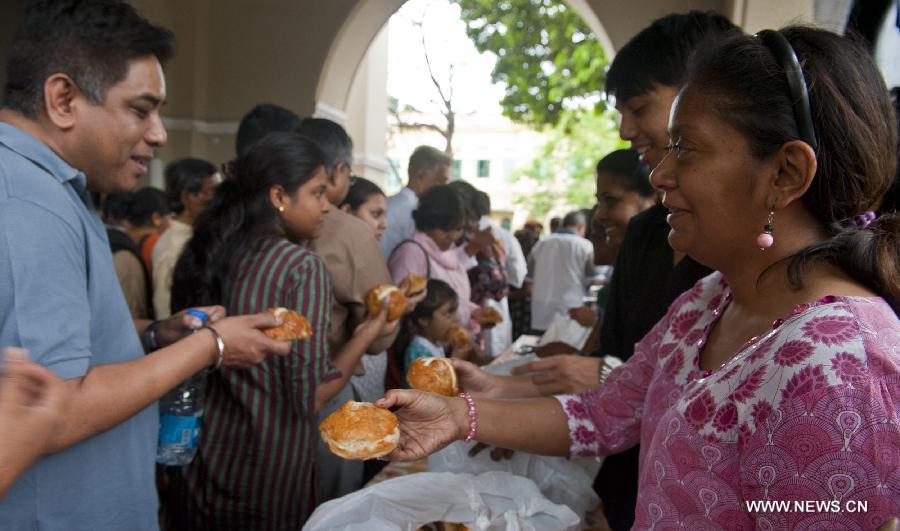Indian Christians share Easter buns during Good Friday celebration at a church in Calcutta, capital of eastern Indian state West Bengal, March 29, 2013. Christians all over the world marked Good Friday, the day when Christ was crucified. (Xinhua/Tumpa Mondal) 