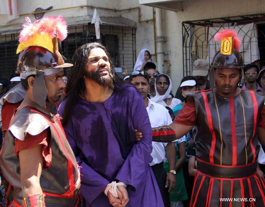People watch a passion play on Good Friday to mark Easter in Mumbai, India, March 29, 2013. Passion play is a dramatic presentation depicting the suffering and death of Jesus Christ and part of the Good Friday celebrations. (Xinhua/Stringer) 