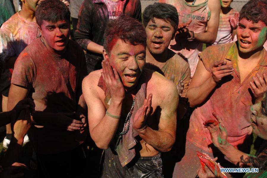 Students of University of British Columbia sing and throw coloured powder on each other as they celebrate Holi, the Indian Festival of Colors, in Vancouver, Canada, on March 30, 2013. Holi is all about celebrating the colors and vitality of spring, with family and friends. (Xinhua/Sergei Bachlakov) 