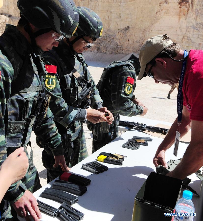 Chinese paramilitary personnels receive bullets in the 5th Warrior Competition held at King Abdullah Special Operation Training Center (KASOTC) in Amman, Jordan, March 28, 2013. The competition with wide participation of 33 teams from 18 countries is held from March 24 to March 28. (Xinhua/Cheng Chunxiang)