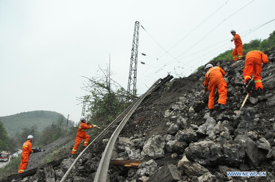 Rescuers work at the site where a landslide hit one section of Chongqing-Guiyang Railway in southwest China's Guizhou Province, March 31, 2013. The landslide caused 2 trains off-the-line and 5 trains rechannel. (Xinhua/Zhou Tao)