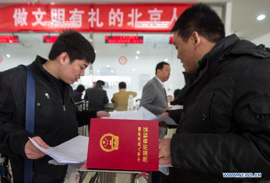 Citizens pay taxes for housing transaction at the Sixth Taxation Office of the Chaoyang District Local Taxation Bureau on the first working day after the Beijing government announced detailed property curbs in Beijing, capital of Beijing, April 1, 2013. The municipal government of Beijing on March 30 spelled out detailed rules aimed at cooling the property market following the central government's fresh regulatory plan earlier this month. Single adults with a permanent Beijing residence registration, who have not made purchases in the city before, are allowed to buy only one apartment, according to the announcement. Meanwhile, the city will raise down payments for second-home buyers and vow to strictly implement the 20-percent tax on capital gains from property sales. (Xinhua/Luo Xiaoguang)