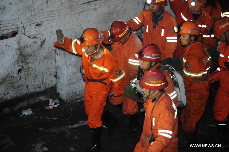 A rescued miner is carried out of the mine shaft of a flooded coal mine in Weng'an County, southwest China's Guizhou Province, April 8, 2013. Three miners trapped in the flooded Yunda Coal Mine for about 60 hours were rescued early Monday morning. Three others remained missing at the mine, which was hit by flood last Friday. Rescuers had earlier confirmed that three miners had been dead. (Xinhua/Liu Xu)