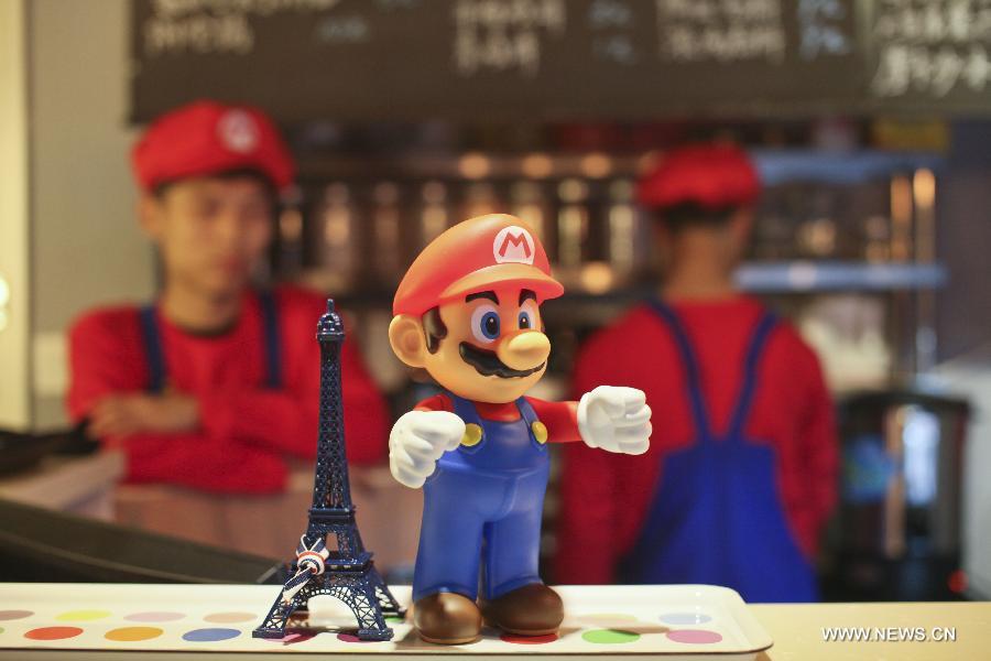 Waiters in the costume of Super Mario, a famous video game character, work at a Mario themed restaurant in Tianjin, north China, April 8, 2013. The restaurant that opened on Monday attracted many young customers due to its "Mario-like" waiters and various decorations. (Xinhua/Fu Wenchao)