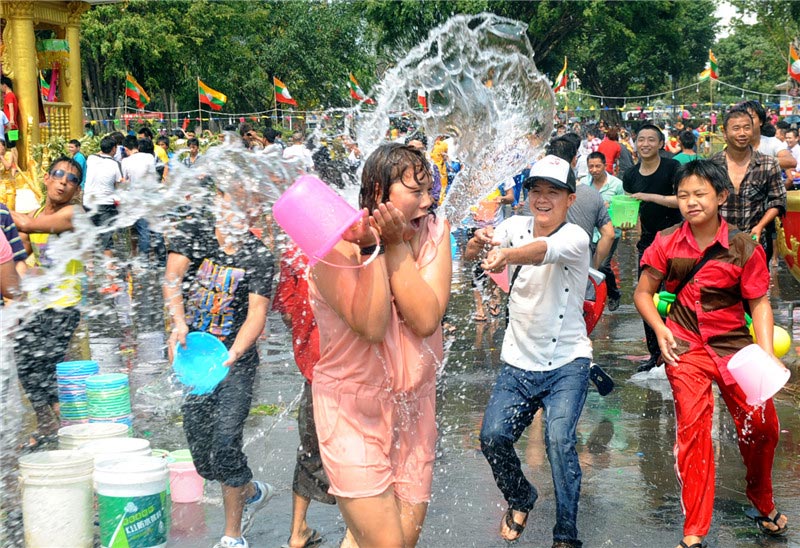 A woman is drenched in the Water Splashing Festival celebrations in Dehong Dai and Jingpo autonomous prefecture in Yunnan on April 11, 2013. (Xinhua)