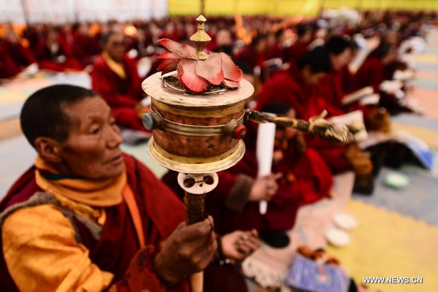 A Buddhist nun prays for the victims during a Buddhist commemoration marking the third anniversary of the Yushu earthquake, in Yushu Tibetan Autonomous Prefecture, northwest China's Qinghai Province, April 14, 2013. A 7.1-magnitude earthquake hit Yushu on April 14, 2010, leaving 2,698 dead and over 12,000 injured. (Xinhua/Zhang Hongxiang) 