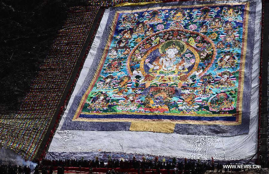 Photo taken on April 14, 2013 shows a gigantic tangka during a Buddhist commemoration marking the third anniversary of the Yushu earthquake, in Yushu Tibetan Autonomous Prefecture, northwest China's Qinghai Province, April 14, 2013. A 7.1-magnitude earthquake hit Yushu on April 14, 2010, leaving 2,698 dead and over 12,000 injured. (Xinhua/Zhang Hongxiang) 