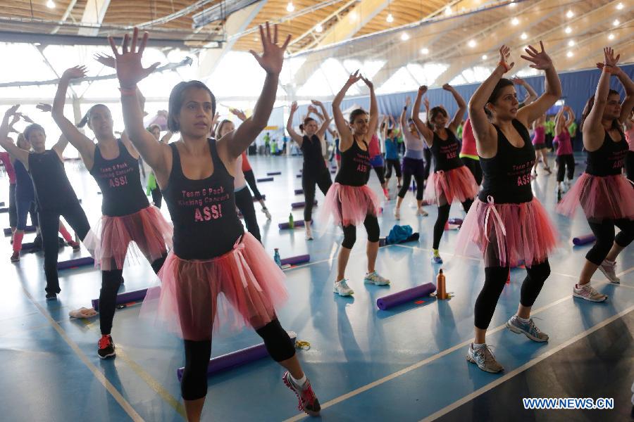 Ladies participate in a marathon exercise fund raising event at the Richmond Oval in Richmond, Canada, on April 13, 2013. Over 300 women take part in a marathon seven-hour dance at the Bust a Move event to raise fund for BC Cancer Foundation in order to help fighting against the breast cancer. (Xinhua/Liang Sen)