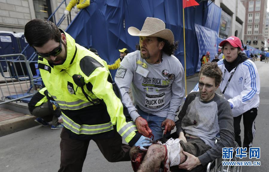 People react following explosions happened in Boston, the United States, April 15, 2013. Three explosions occurred near the Boston Marathon finish line, killing at least 2 people, local media reported. (Xinhua/Zhao Xirong) 