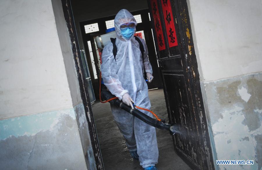 A staff member wearing a protection suit spray disinfectant in the house whose proprietor surnamed Chen in Chajian Town of Tianchang City, east China's Anhui Province, April 16, 2013. Chen was tested positive for H7N9 virus on April 15, according to the provincial health department in Anhui. Chen's residence and areas nearby were disinfected thoroughly on April 16. (Xinhua/Du Yu) 